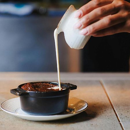 Stock Exchange Hotel, Manchester, Autograph Collection מראה חיצוני תמונה A pot of chocolate pudding being topped with cream