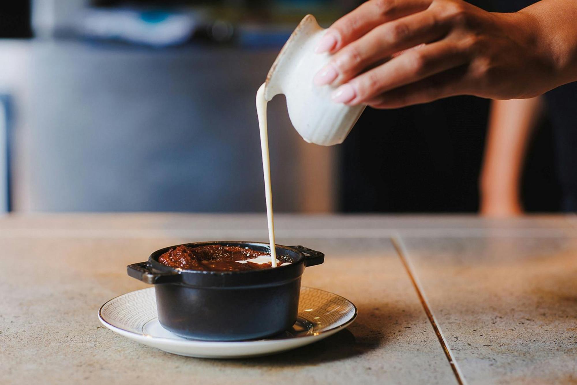 Stock Exchange Hotel, Manchester, Autograph Collection מראה חיצוני תמונה A pot of chocolate pudding being topped with cream
